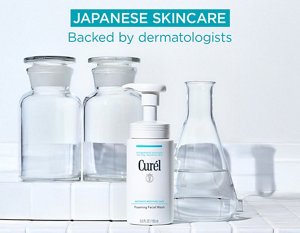 The Curél Foaming Facial Wash surrounded by chemistry glass beakers